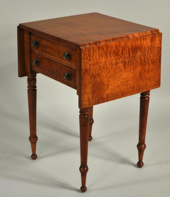 Sheraton Figured Maple Drop Leaf Work Table: Sheraton figured maple two drawer drop leaf work table, circa 1820, on turned legs with ball feet. 29" high, 20 1/4" wide (closed) 40" wide (open), 19" deep. Condition: couple scratches, age crack to 