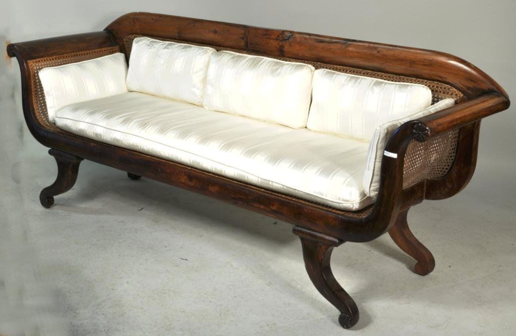 Chinese Export Regency Sofa, 19th C.: Chinese export, possibly padouk wood, regency sofa, 19th C., caned seat, back and sides on curved legs. 33" high, 83" wide, 23" deep. Condition: restoration, age cracks.