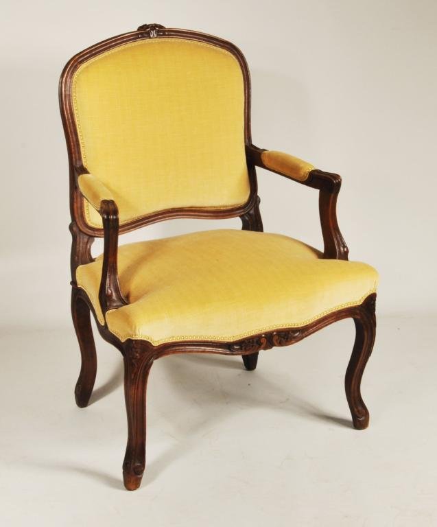 Louis XV Style Fauteil: Louis XV style fauteuil armchair, with carved rosette knees and crest, in yellow velvet upholstery, 20th C. 36 3/4" high, 25" wide, 24" deep.