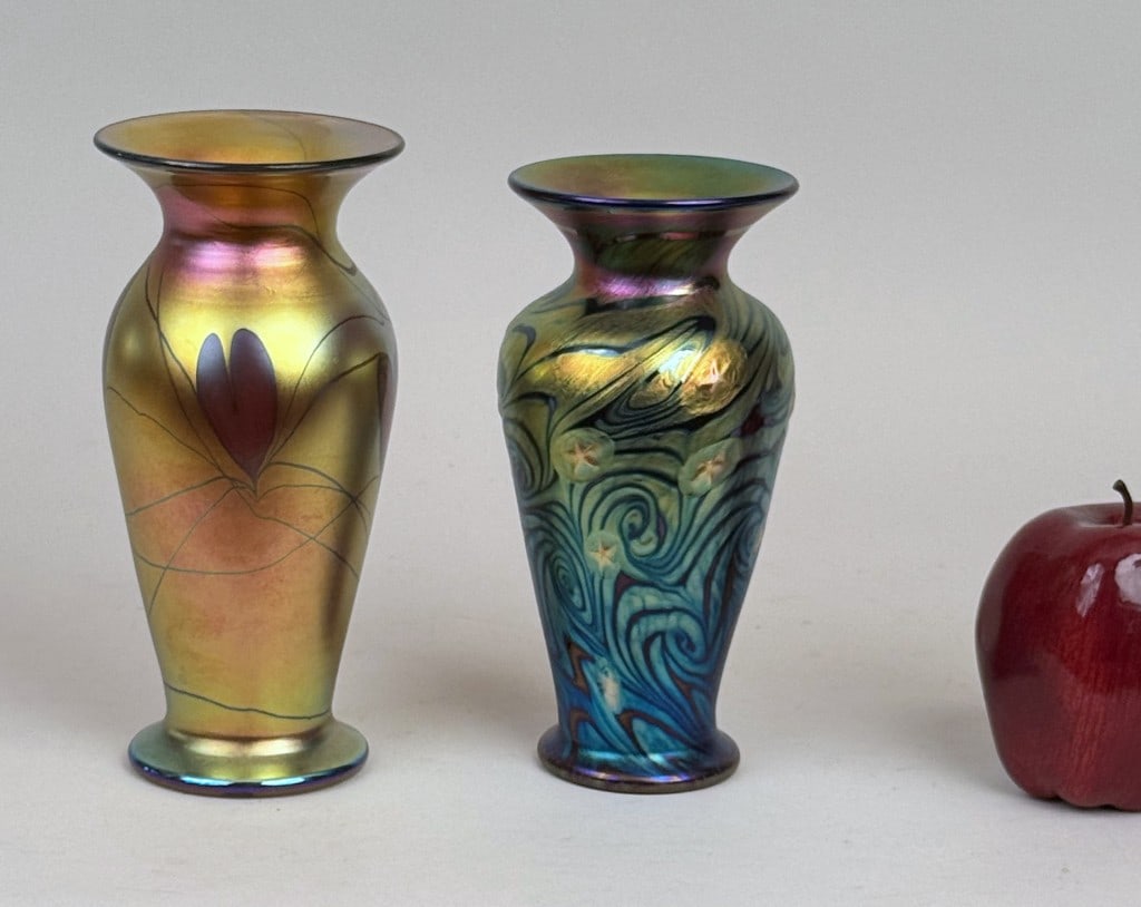 Two Lundberg Studios Art Glass Vases: iridescent baluster form vases, the smaller "Starry Night", 2000; the larger "Hanging Hearts", 1999, each signed, dated and numbered underside. Larger: 7 1/8" high, 3 3/8" diameter.