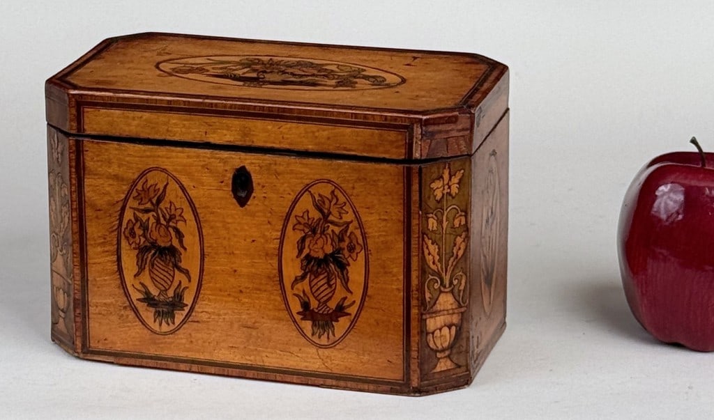 Antique English Inlaid Satinwood Tea Caddy: with canted corners and floral paterae inlays. 5" high, 7 1/2" wide, 4 1/2" deep. Veneer losses, damage to compartment liners.