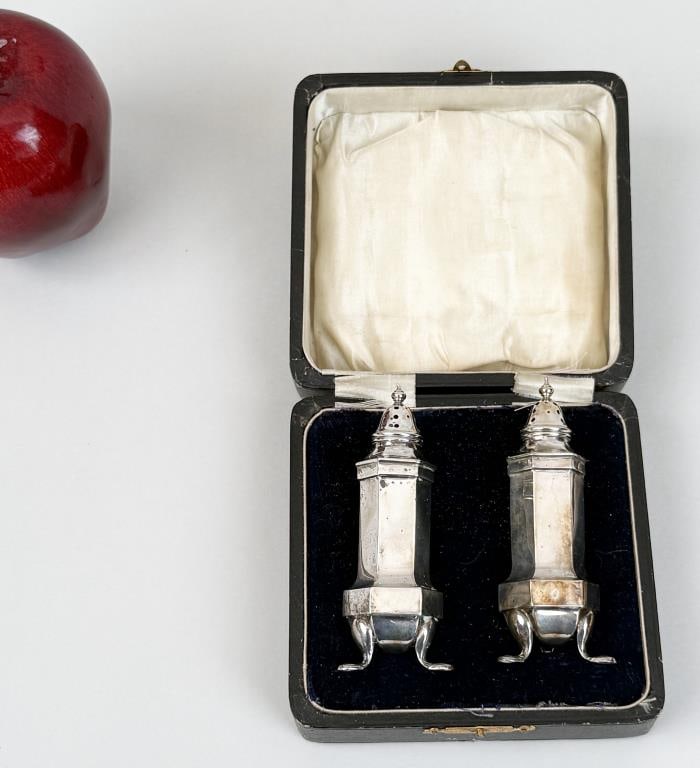 Pair Cased English Sterling Salt & Pepper Shakers: 3 3/4" high, 1 3/8" wide, 1 3/8" deep. Worn hallmarks, oxidation. Weight: 1.310 OZT. *No credit card payments will be accepted for silver, gold, or jewelry from buyers that have not purchased from our