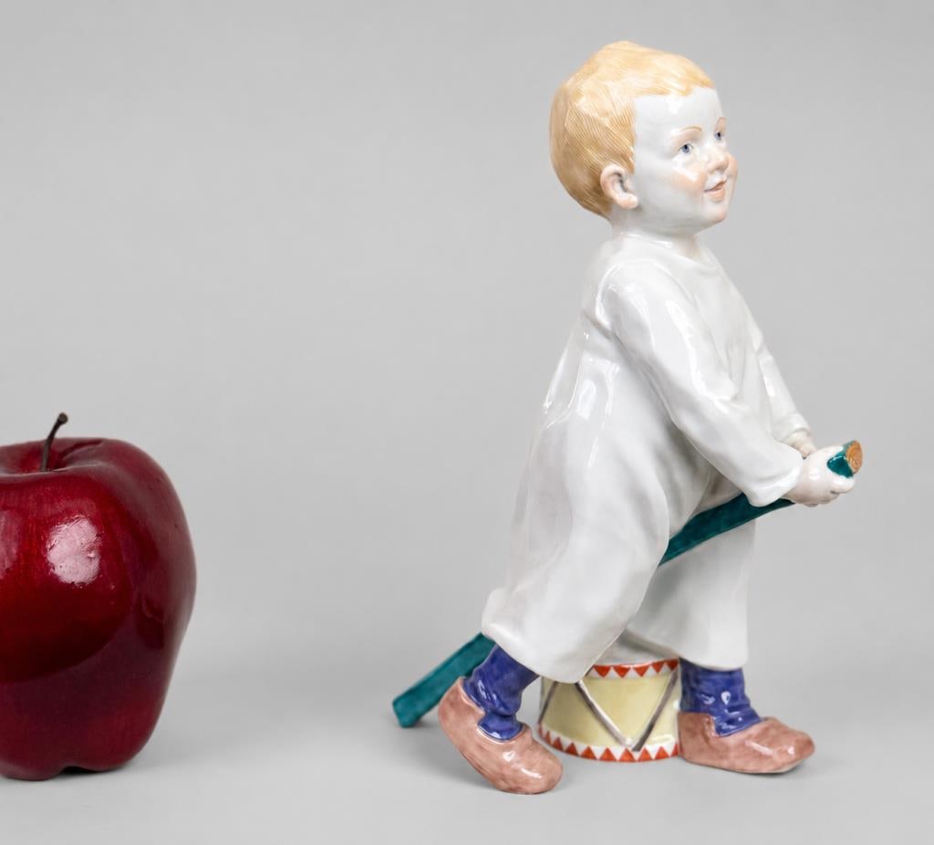 Meissen Hentschel Porcelain Child Figure: Konrad Hentschel (1872-1907) for Meissen, porcelain model of a standing child riding on a stick with a drum, blue crossed swords mark and numbered underside. 7 1/2" high, 3" wide, 4 3/4" deep.
