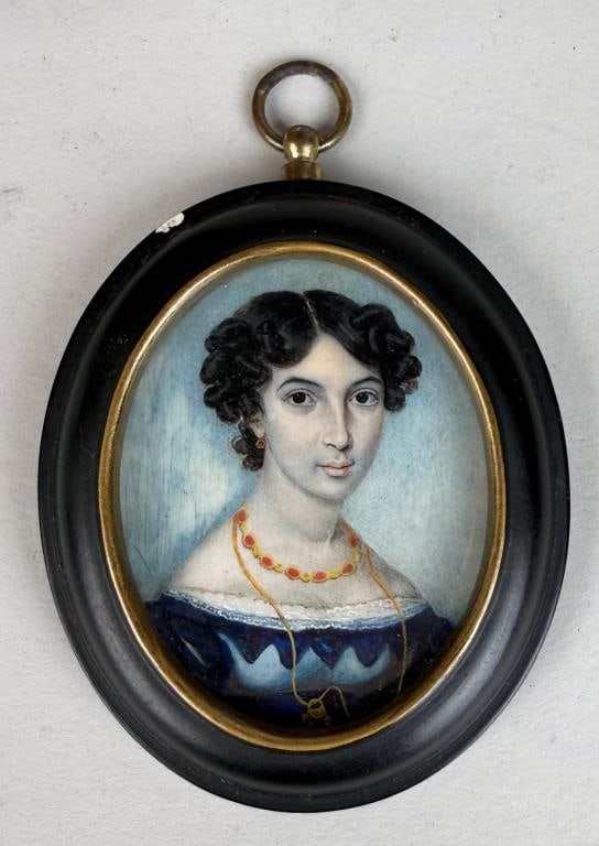 American Portrait Miniature Of Lady: in a blue dress and wearing fine gold jewelry. Frame size: 3 3/4" high, 2 5/8" wide. Chip to frame. Not examined out of frame. Provenance: Geisler Brothers Pittsburgh, PA.