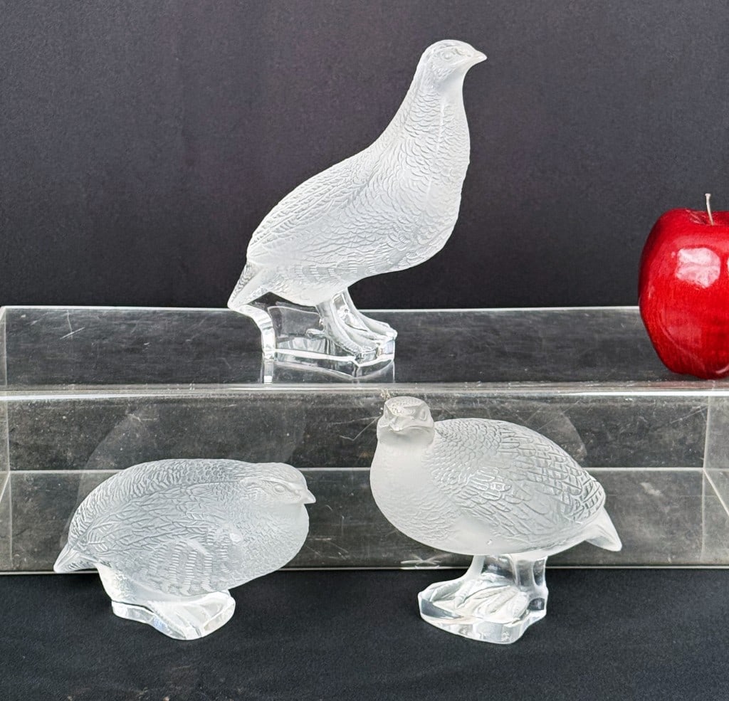 Three Lalique Quail Bird Figures: frosted glass, each signed underside. Largest: 7" high, 5 1/2" wide , 3 1/2" deep. Largest with chip to base, small chip to one chick.