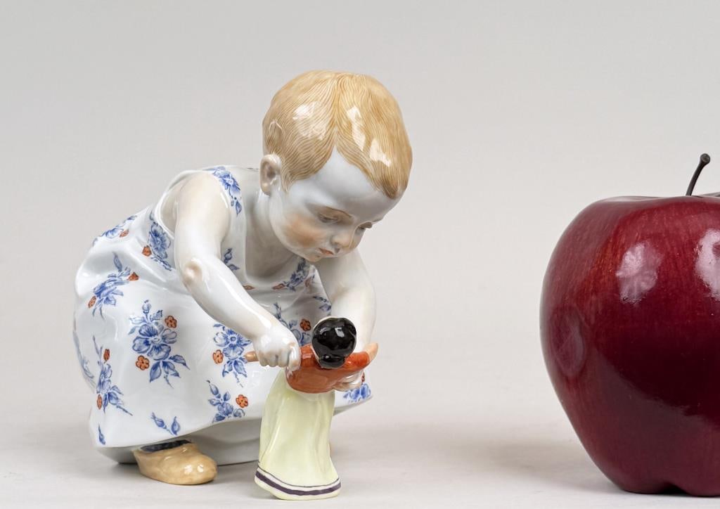 Meissen Hentschel Porcelain Girl With Doll: Konrad Hentschel (1872-1907) for Meissen, porcelain model of a young girl with her doll, blue crossed swords mark and numbered underside. 4 1/2" high, 3 1/2" wide, 5" deep.