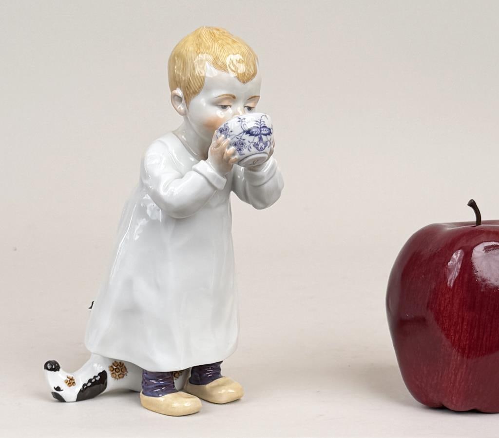 Meissen Hentschel Young Boy Porcelain Figure: Konrad Hentschel (1872-1907) for Meissen, porcelain model of a seated young boy with toy horse drinking from a blue and white bowl, blue crossed swords mark and numbered underside. 6 3/4" high, 3 1/2"