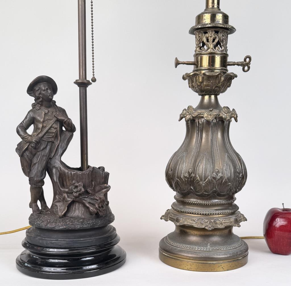 Two Spelter Table Lamps: the smaller figural featuring a boy. The larger: 25" high, 6" diameter base. Age and use wear.