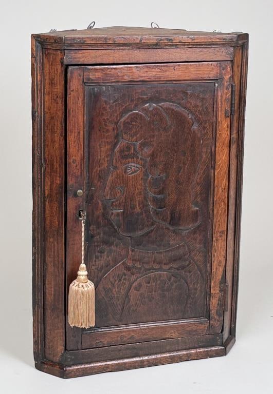Portrait Carved Oak Corner Wall Cabinet: with carved relief of Renaissance style man. 33" high, 21 1/2" wide, 13" deep. Age and use wear. Provenance: Ned Fox Antiques