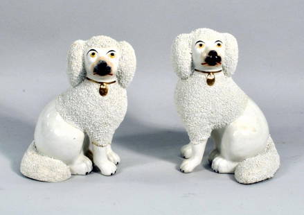 Pair Small Staffordshire Poodles: Pair of English Staffordshire poodles, 19th century, with sieved clay coats, each wearing a gilt collar with locket. 7 1/4" high, 5 1/4" wide. Condition: one with broken, repaired front legs, gilt