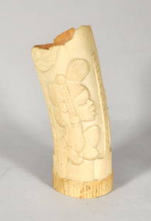 African Carved Ivory Tusk: African carved ivory tusk, 20th century, depicting a woman and an elephant. 9 1/4" high, 3 1/2" wide. Condition: age cracks, losses