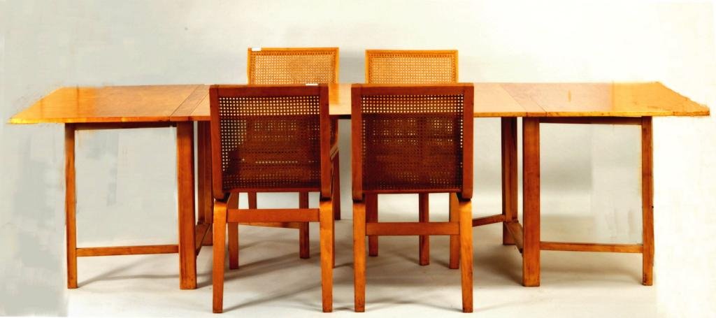 Danish Modern Walnut Dinette Set: Danish modern wood dinette set, 20th century, four laminated Bentwood side chairs with caned seats and backs, together with a large expanding dropleaf tuck-a-way type dining table. Chair: 33 1/2" high