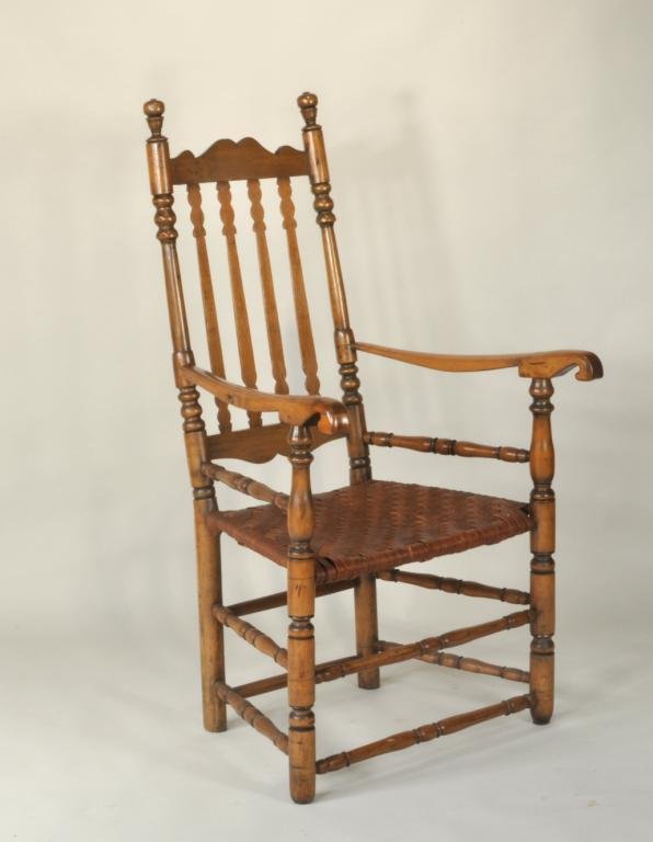 NE Queen Anne Banister Back Arm Chair: New England Queen Anne, maple and oak, banister back armchair, 18th/19th century, having a shaped crest rail over four turned split banisters, flanked by knob turned stiles, with scrolled arm rests on