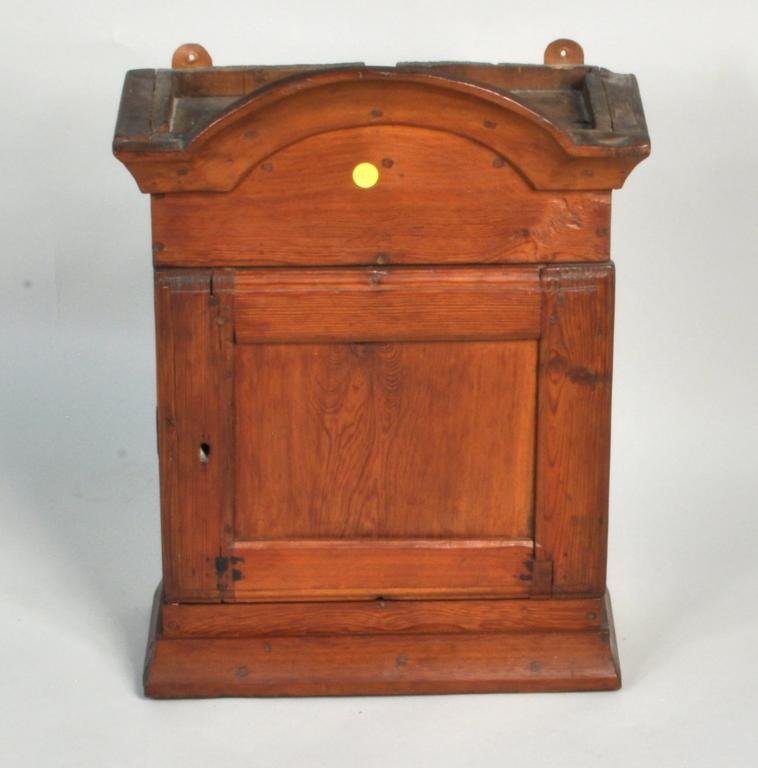 Continental Dome Top Hanging Cabinet: Continental pine dome top hanging cabinet, 18th century, with molded arched cornice over single paneled door, one interior shelf. Dimensions: 21 1/2" high, 16 1/4" wide, 7 1/2" deep. Condition: age cr