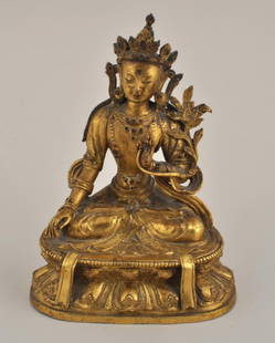 Tibetan Gilt Bronze Seated Figure of Tara: Tibetan gilt bronze seated figure of Tara, probably 19th century, incised Dorje symbol on base. 6 1/4" high, 5" wide. Condition: lacking "jewels" in forehead, crown and jewelry.