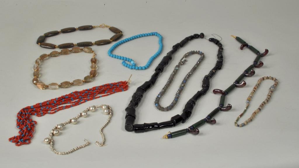 Nine Various Stone, Glass & Silver Bead Necklaces: Nine various stone, glass & silver bead necklaces, mostly 20th century, including an early Roman glass necklace, a Hill tribe .980 silver bell necklace, a strand of black coral, a MMA jade, lapis and 