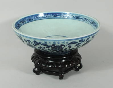 Chinese Ming Dynasty Blue & White Porcelain Bowl: Chinese Ming Dynasty (1368-1644) blue and white porcelain bowl, interior with blue central medallion and interior banding, exterior with floral banding and six character mark on raised foot on wood st