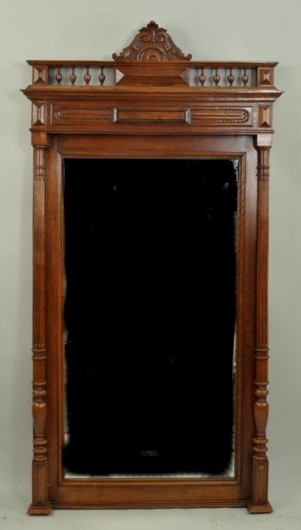 Victorian Eastlake Mahogany Hall Mirror: Victorian Eastlake mahogany hall mirror, 19th century, carved crest over carved and turned top flanked by fluted columns on square shaped base. 73" high, 38 1/2" wide, 5" deep.