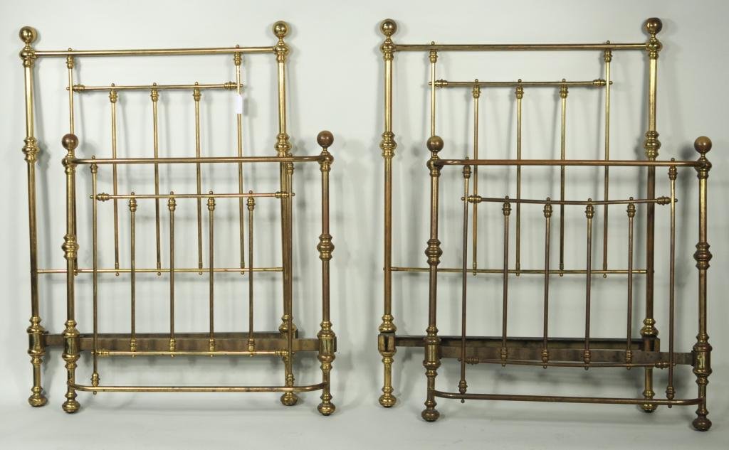 Pair Tubular Brass Twin Beds: Pair of brass twin beds, circa 1900, with turned brass elements on ball feet, including all side rails. Headboard: 51 3/4" high, 36 1/4" wide. Footboard: 36 1/2" high, 36" wide. Condition: dents, bend
