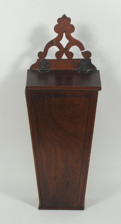 New England Mahogany Wall Hanging Candle Box: New England inlaid mahogany candle box, 19th century, with pierce carved top, tapered form with ebony line inlay. 19" high, 7" wide. Condition: repair to fretwork, top possibly replated, age cracks.