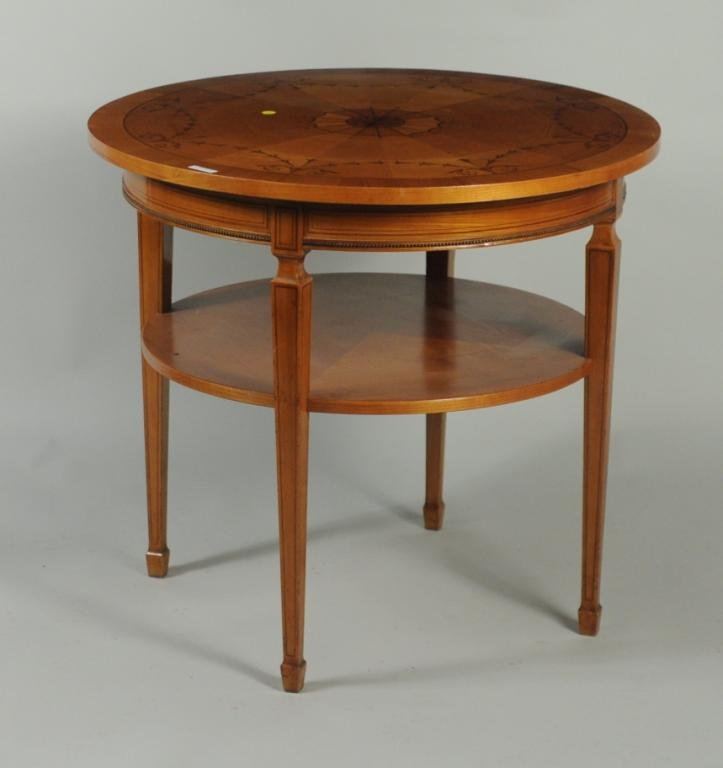 Biedermeier Marquetry Inlaid Center Table: Biedermeier marquetry inlaid center table, circa 1900, top with matched pie wedge veneers and central floral rosette bordered by bellflower swag banding on tapered legs, second shelf below. 28 1/2" hi