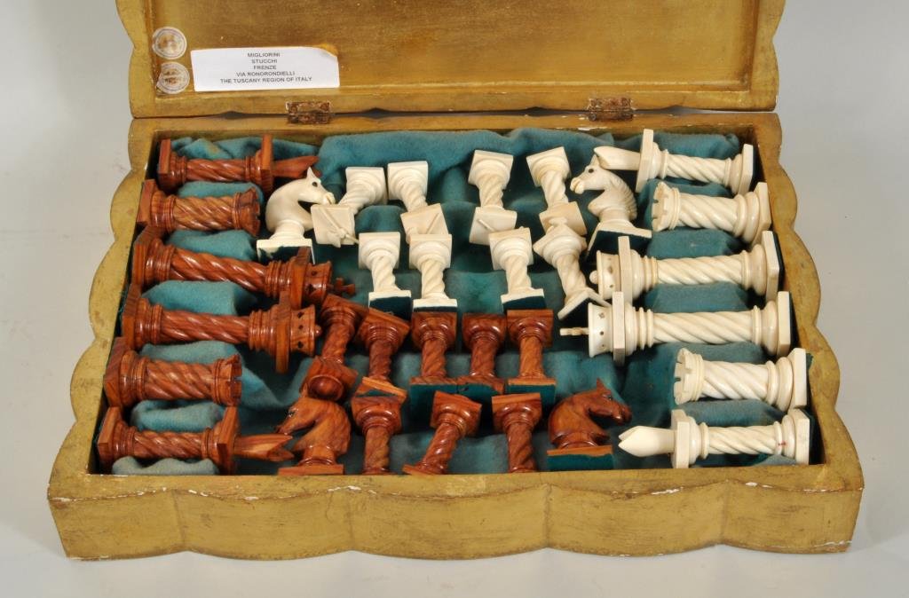 Florentine Carved Ivory/Olivewood Boxed Chess Set: Florentine carved ivory and olivewood chess set, 20th century, in gilt case. 2 1/4" high, 1" wide to 5" high, 1 1/4" wide. Case: 11 3/4" high, 15 1/2" wide. Condition: gilt loss to case. NO INTERNATIO