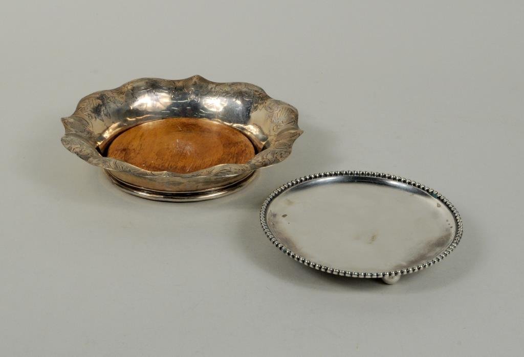 Two .833 Dutch Silver Items: Two .833 Dutch silver items, 19th century, comprising a bottle coaster made in 1860 and a small footed tray made in 1825, makers' mark Meyer, 4 5/8" diameter to 6" diameter. Weight: 5.205 OZT. Conditi