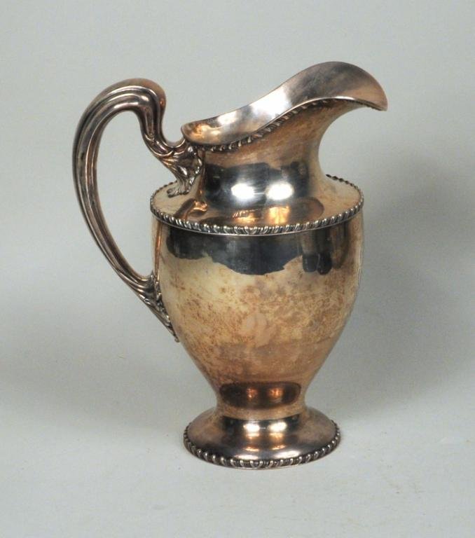 Sterling Silver Pitcher: Sterling silver pitcher by Black Starr & Frost, 20th century, monogrammed. 10 1/4" high, 8 1/2" wide. Weight: 33.670 OZT. Condition: slight dent in base.