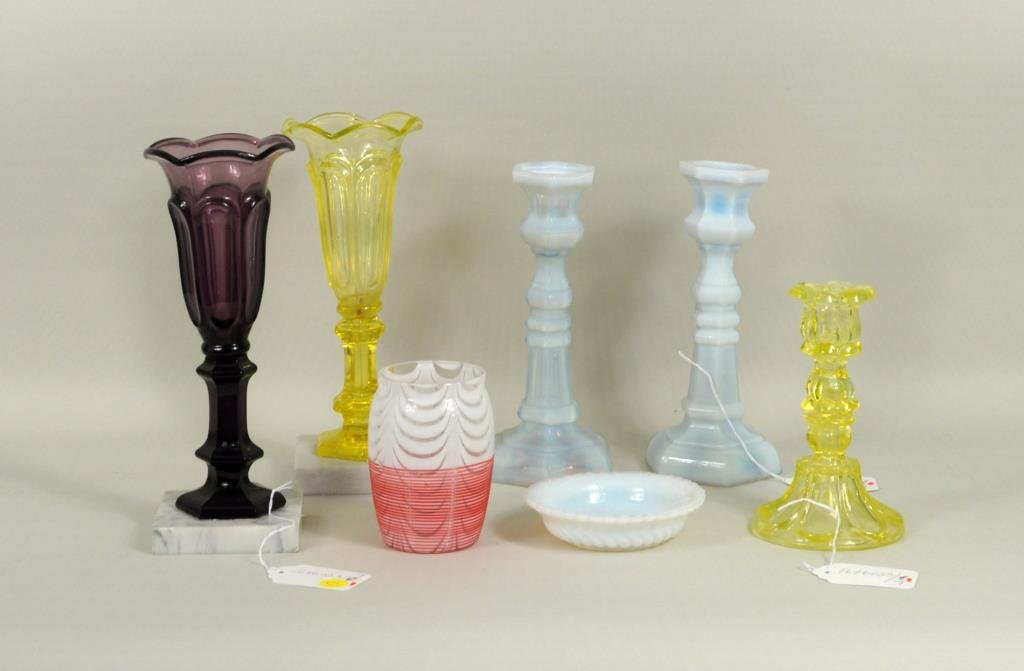 Seven Opalescent & Vaseline Glass Items: Seven opalescent and Vaseline glass items, 19th century, comprising two opalescent candlesticks,a bowl, Vaseline glass candlestick, Vaseline glass urn, a vase, and amethyst urn. 5" diameter to 11" hig
