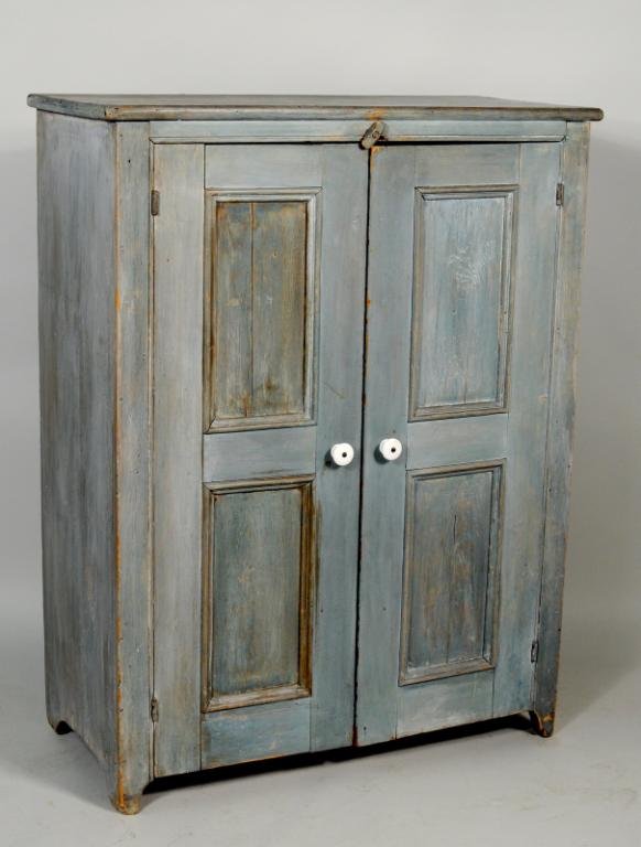 American Painted Two Door Cupboard: American painted two door cupboard, 19th century, in blue paint having two paneled doors, three interior shelves on cutout base. 48" high, 37 1/2" wide, 17" deep. Condition: use wear, paint wear, loss