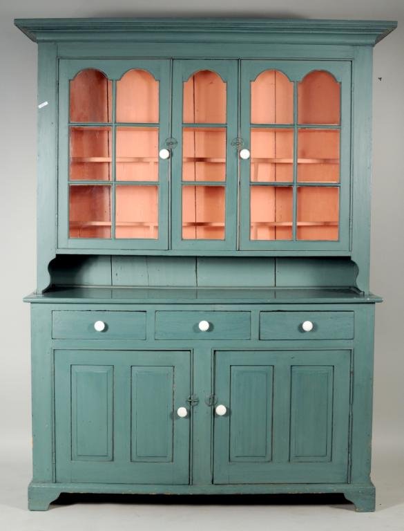 American Country Painted Two Part Pewter Cupboard: American country painted two part pewter cupboard, 19th century, having a molded cornice over two arched glazed cupboard doors, salmon interior with plate rails over base having three drawers over two