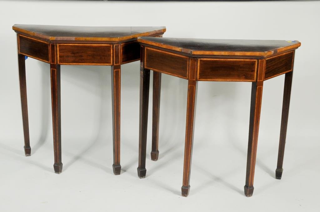 Pair George III Inlaid Mahogany Console Tables: Pair of George III inlaid mahogany console tables of pentagonal shape on tapered legs ending in spade feet. 30" high, 32 1/2" wide,12" deep. Condition: buckling, losses to inlay, restoration, one leg