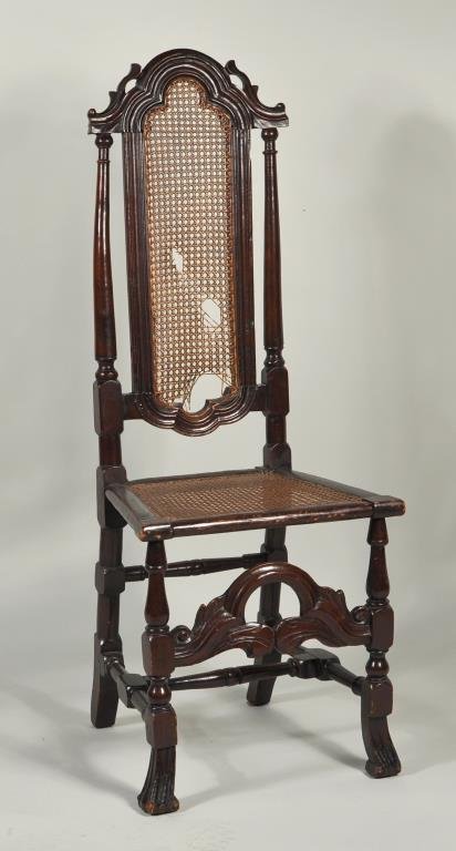William & Mary Carved Beech Side Chair: American or English William & Mary Flemish style carved beech side chair, 17th/18th century, arched foliate crest rail, caned back and seat, turned legs and stretcher on large Spanish feet. Ex. Luke V