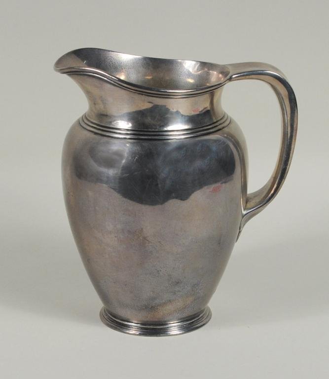 Vintage Tiffany & Co. Sterling Silver Pitcher: Tiffany & Co. sterling silver pitcher circa 1907-1908. 8" high, 7" wide. Weight: 29.835 OZT. Condition: a few small dings, small dent to base.