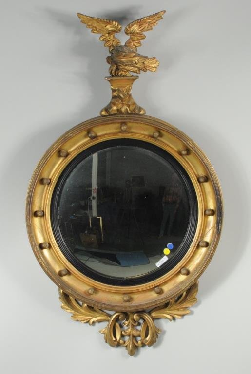 Classical Carved & Gilded Convex Mirror: Classical carved and gilded convex mirror having a crest of a spread winged eagle on rockwork, acanthus leaf carving below. 42 1/2" high, 25" diameter. Condition: gilt wear, loss, age cracks, small lo