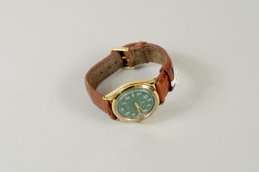 Men's Green Face Rolex Oyster Watch: Men's green face Roman numeral Rolex date watch, original oyster case with leather strap. Marked Rolex Oyster & Tudor on face of watch. In running condition.