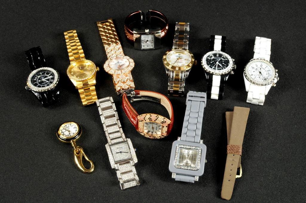 Eleven Mostly Faux Designer Ladies & Men's Watches: Eleven mostly faux designer ladies and men's watches comprising Chanel, Cartier, Rolex and others. Condition: use wear.
