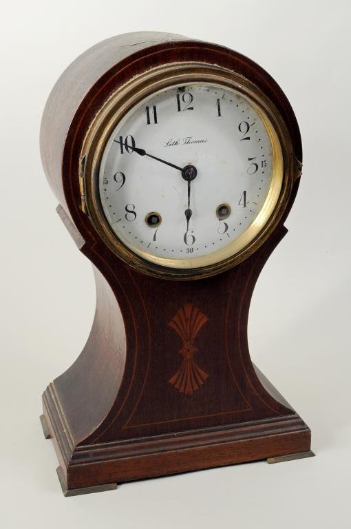 Seth Thomas Mantel Clock: Seth Thomas mantel clock with enamel dial, inlaid mahogany case. 12" high, 7 1/2" wide.