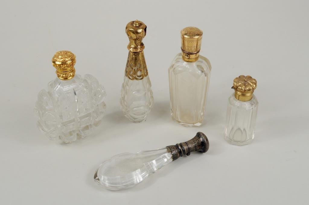 Five Gold & Silver Topped Cut Glass Scent Bottles: Five gold and silver topped cut glass scent bottles, three gold caps with illegible hallmarks, silver capped with monogram. 2 3/4" high, 1 1/4" diameter to 3 3/4" high, 2 3/4" wide.