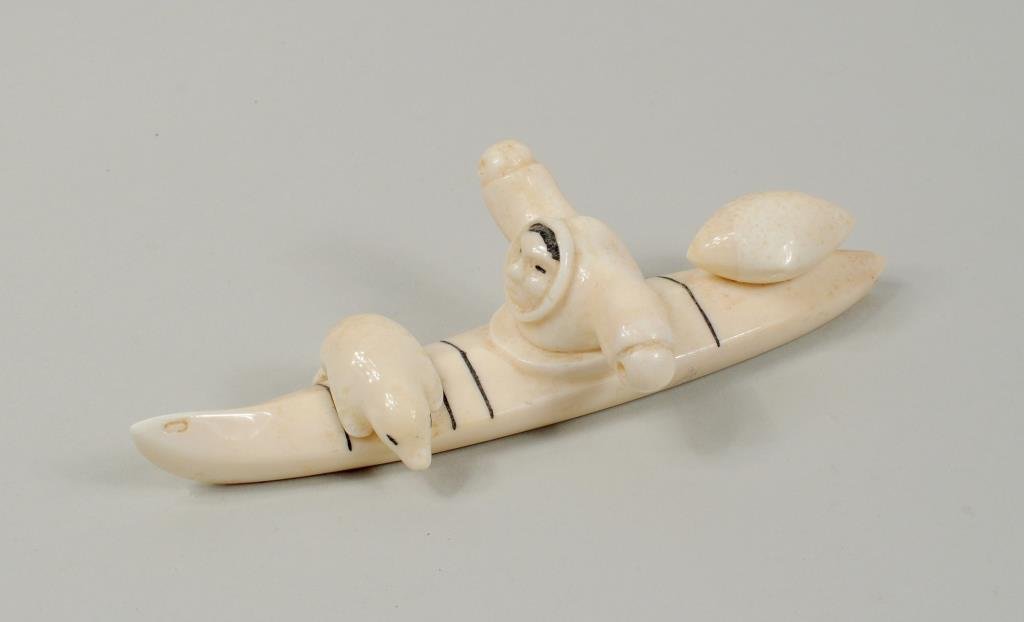 Inuit Marine Ivory Carving of Hunter in Kayak: Inuit marine ivory carving of hunter in kayak, lacking paddles. 6 1/4" long, 2 3/4" wide.