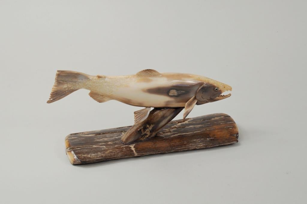 Inuit Carved Fossil Ivory King Salmon Sculpture: Inuit carved fossil ivory sculpture of king salmon, titled, signed on base "Brian Kulik". 3 1/2" high, 6 1/2" long.