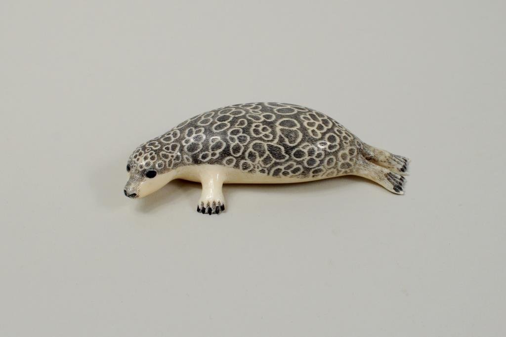 Inuit Scrimshaw Walrus Ivory Leopard Seal: Inuit scrimshaw walrus ivory leopard seal signed on base "Punesuk." 2 1/4" wide, 4" long.