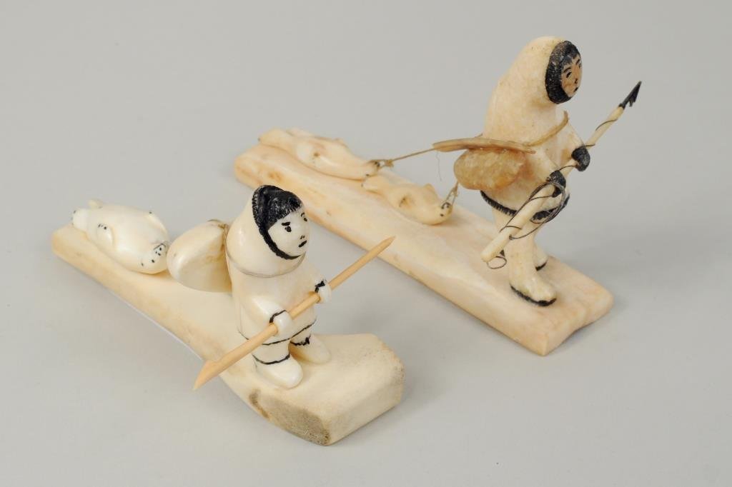 Two Inuit Walrus Ivory & Bone Scrimshaw Carvings: Two Inuit walrus ivory and bone carvings depicting hunters with seals, one initialed "RKS Alaska." 2 1/2" high, 4 1/2" long to 3 1/2" high, 4 3/4" long.