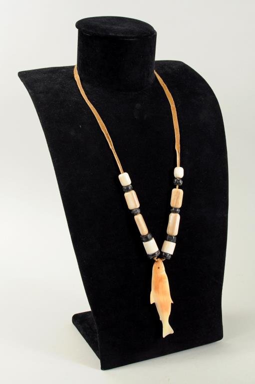 Inuit Carved Marine Ivory Salmon Pendant Necklace: Inuit carved marine ivory salmon pendant necklace, pendant incised "Joe Pungowiyi". Pendant 3 3/8" long, 1" wide, necklace hang length 14" long.