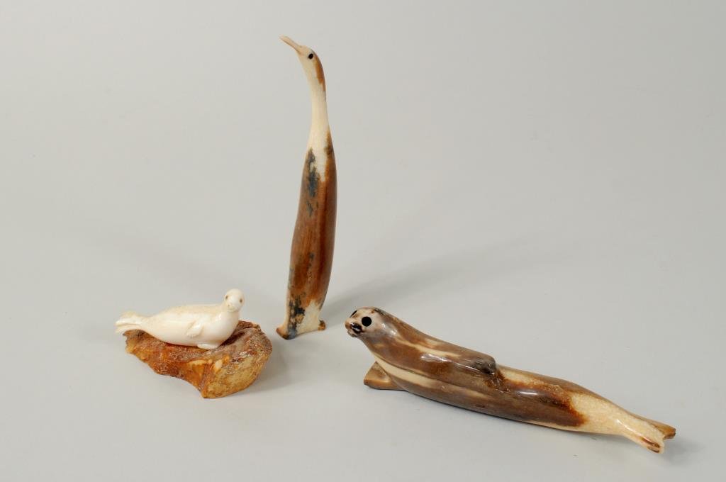 Three Inuit Carved Marine & Fossil Ivory Items: Three Inuit carved marine and fossil ivory items comprising a seal signed illegibly on base, a bird and a small seal signed, dated "Joe Menauq Pungowiyi 89". 1 1/2" high, 2 1/2" wide to 3/4" wide, 5 1