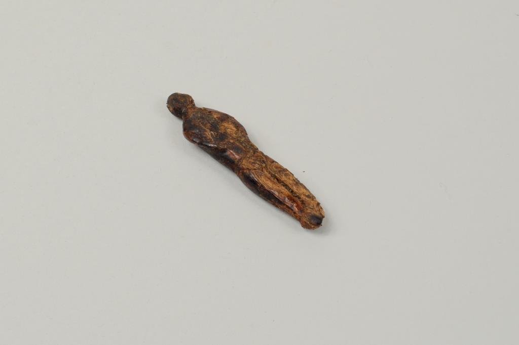 Inuit Carved Fossilized Doll: Inuit carved fossilized doll. 2 1/2" long, 5/8" wide.
