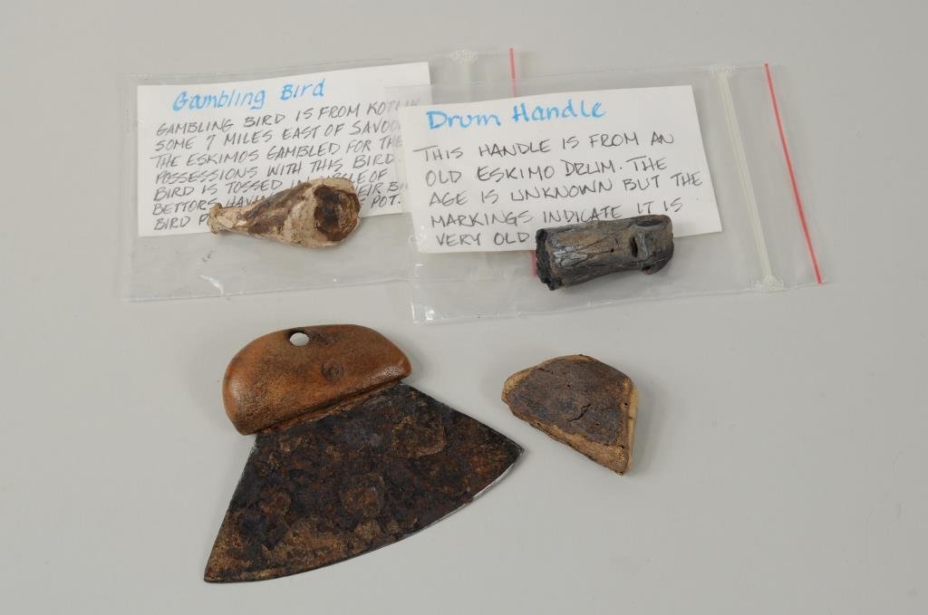 Four Inuit Carved Items: Four Inuit carved items including an Ulu, gaming bird and drum handle. 1 3/4" high, 7/8" wide to 2 5/8" high, 3 5/8" wide.