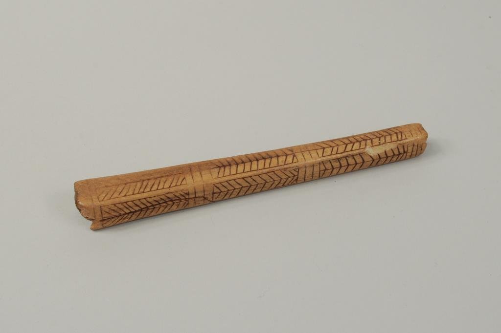 Inuit Carved Bone Needle Case: Inuit carved bone needle case with incised decoration. 5 1/2" long, 1/2" wide.