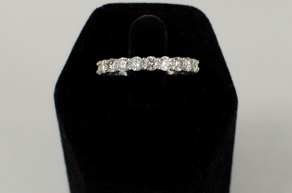 Platinum & Diamond Wedding Band: Platinum and diamond wedding band containing twenty round diamonds weighing 2.02 carats total weight. Diamonds are F color, SI1 clarity set in a common prong platinum mounting. Ring size 6. Gross weig