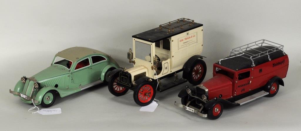 Three Marklin German Toy Cars: Three Marklin German toy cars, including a green windup sedan #1903, and a red windup Reichspost postal truck #1989. 4 3/4" high, 14 3/4" long to 7 1/4" high, 12" long. Condition: soiling, lacking key